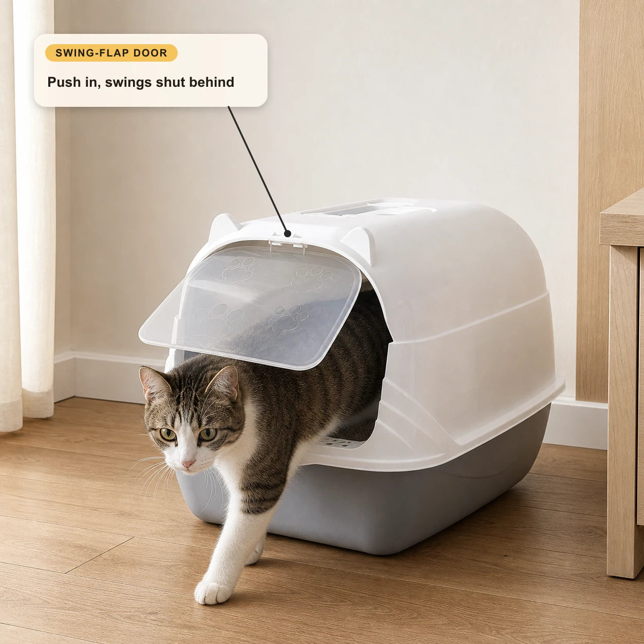 Cat exiting through the translucent two-way swing-flap door of the enclosed litter box, showing push-through entry and exit.
