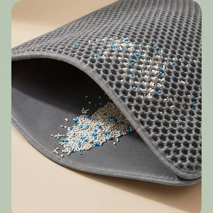 Close up of honeycomb litter mat trapping litter granules