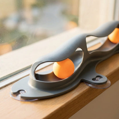Close up of grey windowsill cat track ball toy and suction cups
