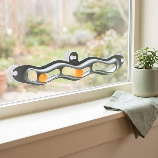Grey windowsill cat track ball toy on a clean windowsill